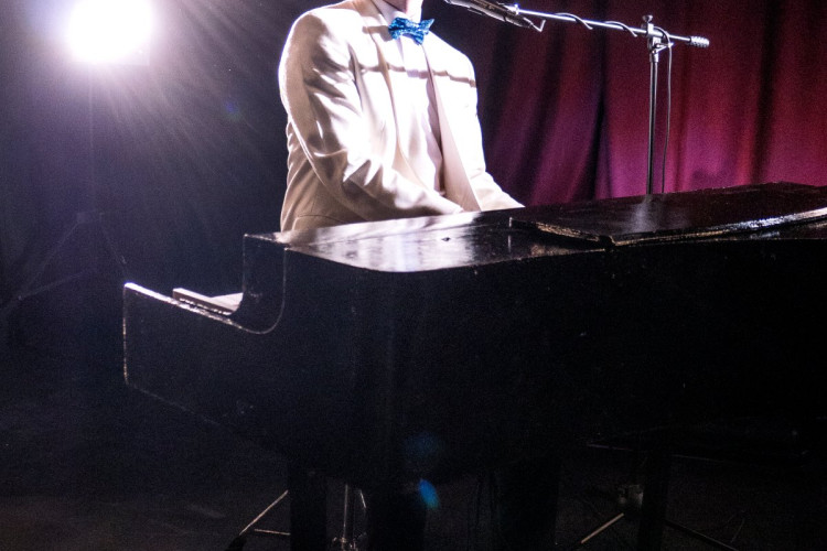 Elton John tribute performing under stage lights