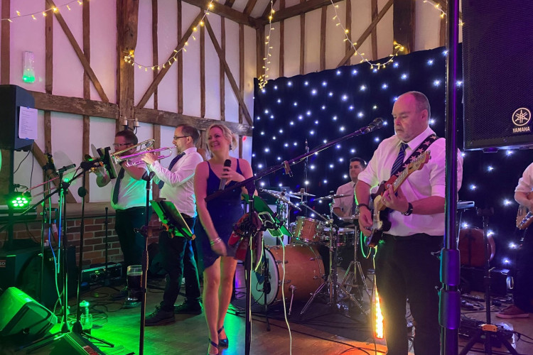 Reunion wedding entertainment live with trumpet and trombone in a timber barn