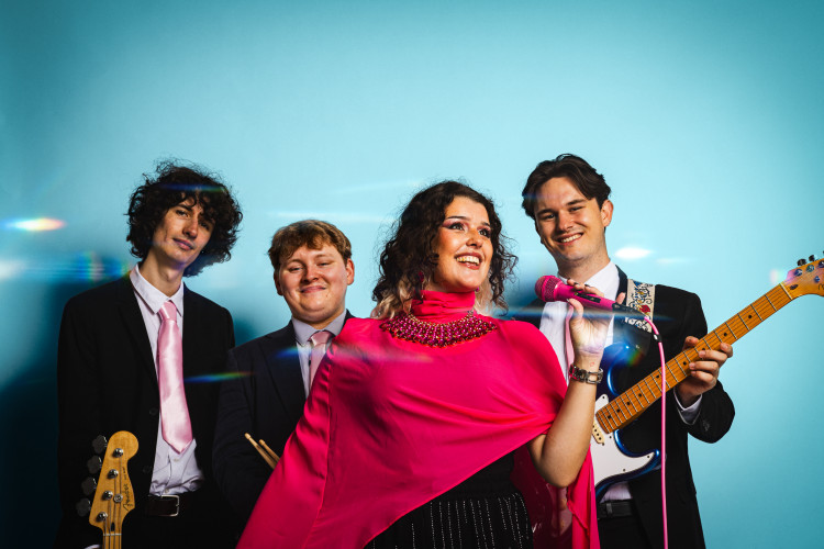 Blush Wedding Band Group Portrait with Guitar Blue Backdrop