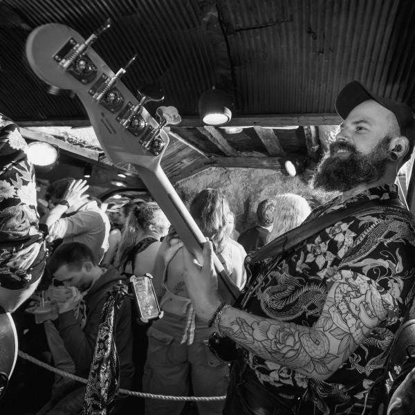 the honey corporate band bassist performing to crowd live venue