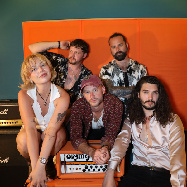 the honey function band close group pose amps string lights