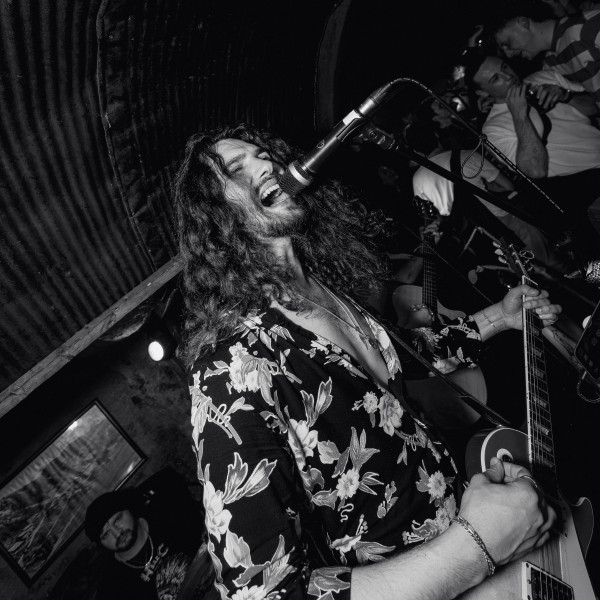 the honey party band vocalist guitarist singing passionately live