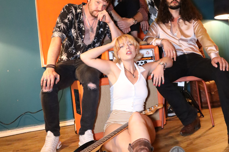 the honey wedding band members piled together playfully studio