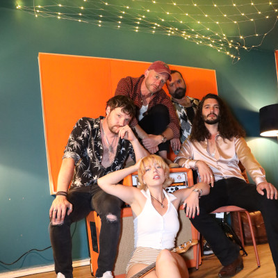 the honey wedding band members piled together playfully studio