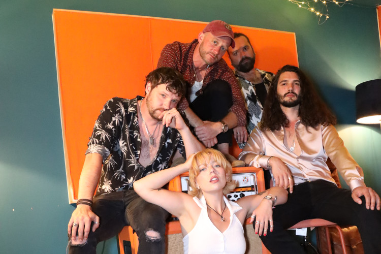 the honey wedding band members piled together playfully studio