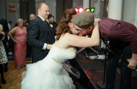 A bride speaking to a member of her wedding band
